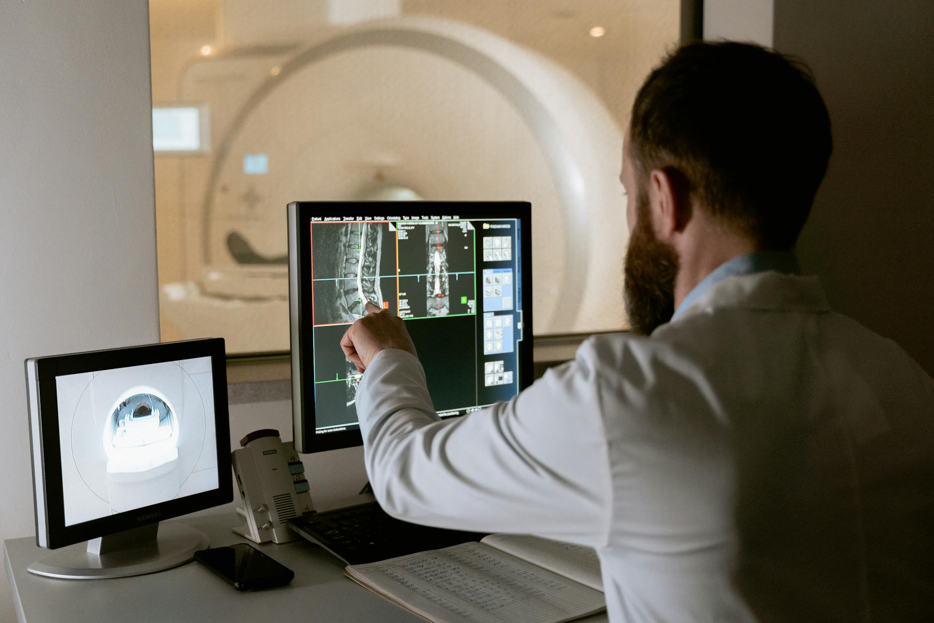 Radiologist working with medical imaging screens